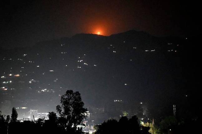 A flare goes up in air over the hill near main town of Poonch district, on May 7, 2025. India said on May 7 it carried out “precision strikes at terrorist camps” inside Pakistan and Pakistani-controlled Kashmir, days after it blamed Islamabad for a deadly attack on the Indian side of the contested region. - Punit PARANJPE / AFP
