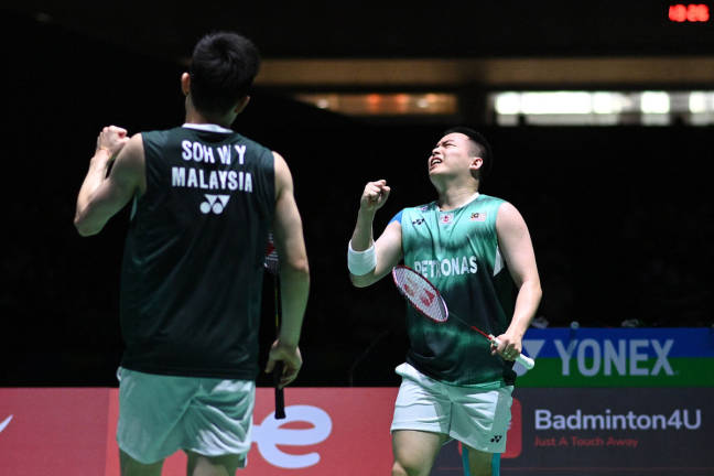 Aaron Chia (R) reacts after a point with partner Soh Wooi Yik (L) of Malaysia as they play against Chirag Shetty and Satwiksairaj Rankireddy of India during their men’s doubles semi-final match on day six of the Badminton World Championships in Tokyo on August 27, 2022. - AFPpix