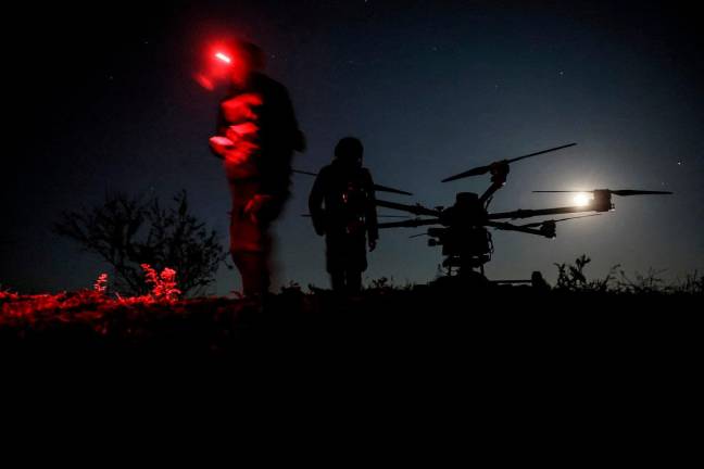FILE PHOTO: Servicemen of 24th Mechanized Brigade named after King Danylo of the Ukrainian Armed Forces stand near a Kazhan heavy combat drone before flying it over positions of Russian troops, amid Russia’s attack on Ukraine, near the frontline town of Chasiv Yar in Donetsk region, Ukraine May 15, 2025. Oleg Petrasiuk/Press Service of the 24th King Danylo Separate Mechanized Brigade of the Ukrainian Armed Forces/Handout via REUTERS