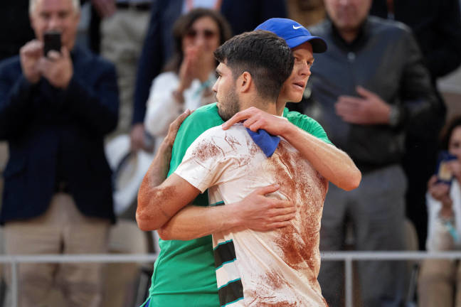 Carlos Alcaraz of Spain and Jannik Sinner of Italy after the men’s singles final match on day 15 at Roland Garros Stadium on Jun 8, 2025. Credit: Susan Mullane via REUTERS
