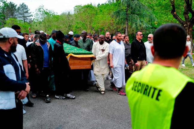Attendees carry the coffin of Aboubakar Cisse as they walk past the Khadija Mosque in La Grand-Combe, southern France, on May 2, 2025, as part of the funeral prayer in tribute to Cisse, a worshipper killed by dozens of stab wounds inside the mosque on April 25th. A week after the murder, around 700 faithful, according to AFP, prayed inside and outside the building. Cisse was originally from the locality of Yaguine, in the Kayes region (along the border with Mauritania), where he is now due to be buried at an unspecified date. - Sylvain THOMAS / AFP