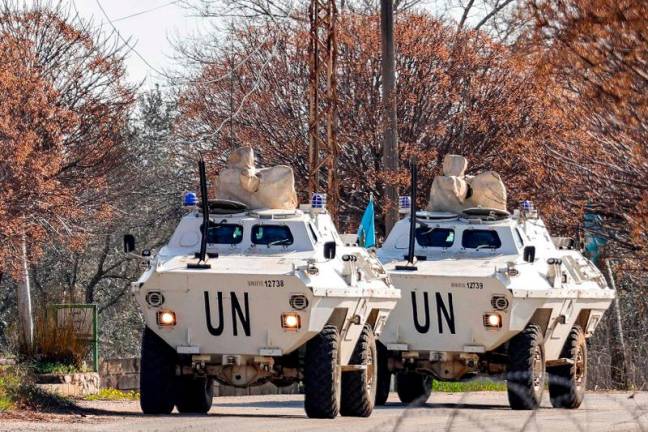 Armoured vehicles of the United Nations Interim Force in Lebanon (UNIFIL) approach a Lebanese army roadblock near a checkpoint in the village of Burj el-Meluk in Nabatiyeh in southern Lebanon near the border with Israel on January 25, 2025. - AFPpix