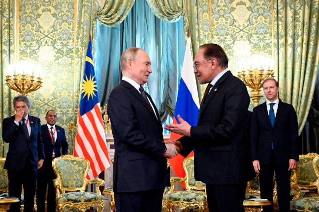 Russian President Vladimir Putin meets with Malaysia’s Prime Minister Anwar Ibrahim at the Kremlin in Moscow on May 14, 2025. (Photo by Alexander NEMENOV / POOL / AFP)