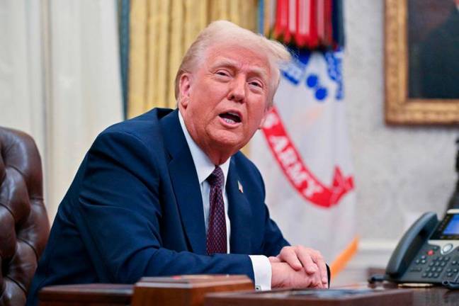 US President Donald Trump speaks to the media after signing executive orders in the Oval Office of the White House in Washington, DC, on January 23, 2025. - ROBERTO SCHMIDT / AFP