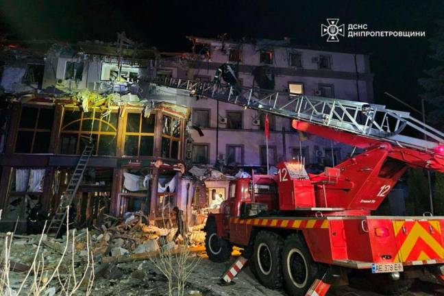 This handout photograph taken and released by the State Emergency Service of Ukraine on March 5, 2025, shows a fire fighter truck next to a destroyed hotel building at the site of a strike in Kryvyi Rig, amid the Russian invasion of Ukraine. - AFP PHOTO / STATE EMERGENCY SERVICE OF UKRAINE