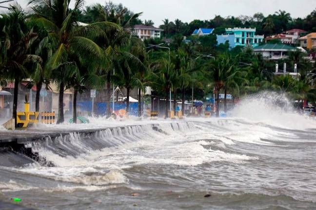 Large waves break along a seawall ahead of the expected landfall of Super Typhoon Man-yi, in Legaspi City, Albay province on November 16, 2024. A super typhoon sweeping towards the Philippines on November 16 was intensifying and could have a potentially catastrophic impact, the state weather forecaster warned, with millions of people at risk from storm surges. - CHARISM SAYAT / AFPpix