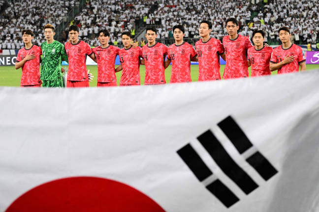 South Korea’s players stand for their national anthem ahead of the 2026 FIFA World Cup Asian Qualifier football match between Iraq and South Korea at Basra International Stadium in Basra on June 5, 2025. - AFPpix