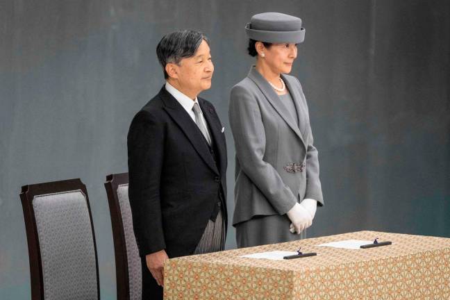 Japan’s Emperor Naruhito (L) and Empress Masako attend a memorial service marking the 80th anniversary of Japan’s surrender in World War II at the Nippon Budokan hall in Tokyo on August 15, 2025. (Photo by Yuichi YAMAZAKI / AFP)