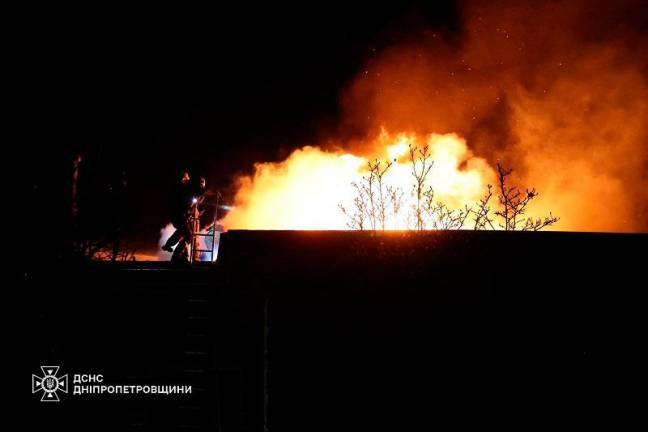 This handout photograph taken and released by the Ukrainian Emergency Service on November 21, 2024 shows Ukrainian firefighters work on a spot following an air-attack, in Dnipro, amid the Russian invasion of Ukraine. Moscow on Thursday launched an intercontinental ballistic missile at Ukraine for the first time, Kyiv said, marking the latest escalation of the conflict after Ukraine fired Western-supplied long-range missiles on Russia. The Ukrainian air force said Russian forces had used the missile in an early morning attack on the city of Dnipro, while a source confirmed to AFP it was the first such use of the weapon by Moscow since the invasion in 2022. - AFP PHOTO / UKRAINIAN EMERGENCY SERVICE