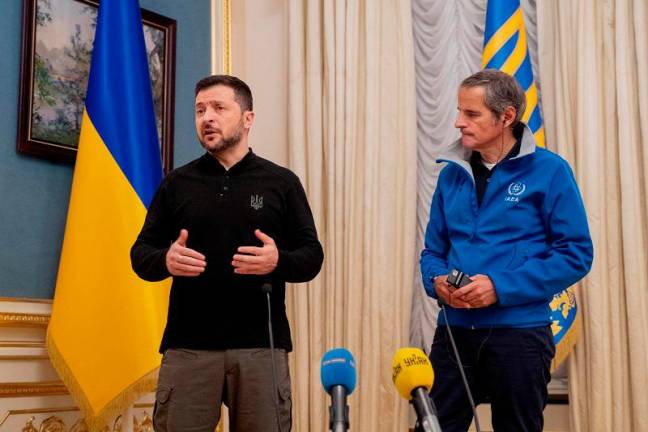 Ukraine’s President Volodymyr Zelensky (L) and International Atomic Energy Agency (IAEA) Director General Rafael Mariano Grossi (R) speak to the press during ther meeting in Kyiv on February 4, 2025, amid the Russian invasion of Ukraine. -Tetiana DZHAFAROVA / AFP