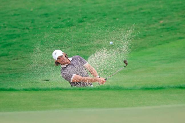 Tommy Fleetwood of England plays a shot from a bunker on the 18th hole during the third round of the TOUR Championship 2025 at East Lake Golf Club in Atlanta, Georgia. - Getty Images/AFP