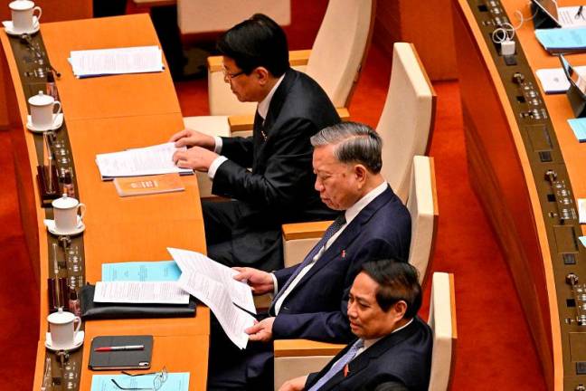(L-R) Vietnam’s President Luong Cuong, Vietnam’s General Secretary of the Communist Party To Lam and Vietnam’s Prime Minister Pham Minh Chinh attend the National Assembly’s summer session opening in Hanoi on May 5, 2025. - Nhac NGUYEN / AFP