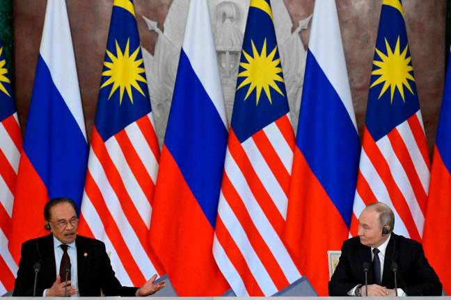 Russian President Vladimir Putin and Malaysian Prime Minister Anwar Ibrahim deliver a joint media statement following their talks at the Kremlin in Moscow, Russia May 14, 2025. Alexander Nemenov/Pool via REUTERS