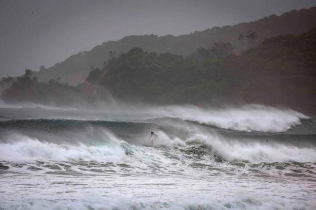 A surfer rides a massive wave stirred by tropical cyclone Alfred at Byron Bay’s Main Beach on March 5, 2025. A rare tropical cyclone veered towards Australia’s densely populated eastern coast, forcing scores of schools to close as worried residents stripped supermarket shelves bare. AFP Pix