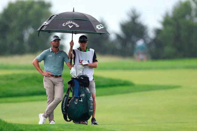 Sam Burns of the United States and caddie Travis Perkins wait to play a shot on the 12th hole during the final round of the 125th U.S. OPEN at Oakmont Country Club on June 15, 2025 in Oakmont, Pennsylvania. - Andy Lyons/Getty Images/AFP