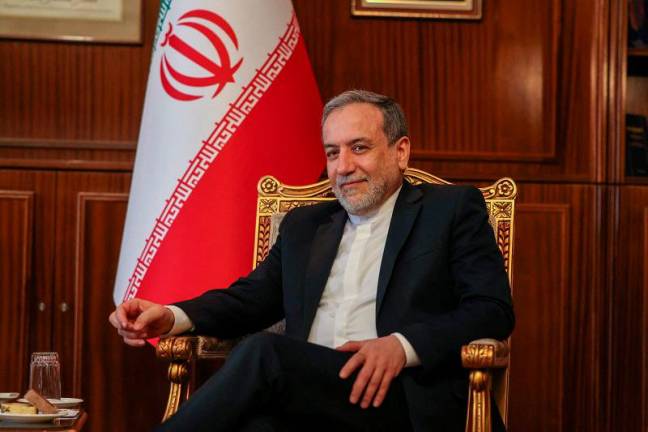 Iran’s Foreign Minister Abbas Araghchi sits for a meeting with the International Atomic Energy Agency (IAEA) Director General in Tehran on November 14, 2024. - Atta KENARE / AFP