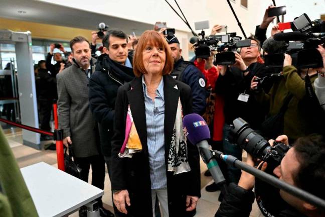 Gisele Pelicot (C) arrives with her lawyers Antoine Camus (L) and Stephane Babonneau (2nd L) at the courthouse in Avignon on December 19, 2024, as the verdict is expected in the trial of her ex-husband, with 50 others, accused of drugging her and orchestrating multiple rapes over nearly a decade. A court in the French southern town of Avignon is trying Dominique Pelicot, a 71-year-old retiree, for repeatedly raping and enlisting dozens of strangers to rape his heavily sedated wife Gisele Pelicot in her own bed over a decade. Fifty other men, aged between 26 and 74, are also on trial for alleged involvement, in a case that has horrified France. - Miguel MEDINA / AFP