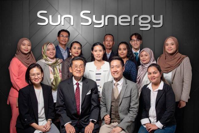 Michael Ng (seated, 2nd from left), Edwin Ng (seated, 3rd from left) and the Sun Synergy team.