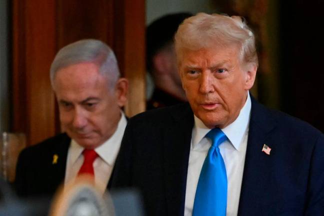 US President Donald Trump and Israel’s Prime Minister Benjamin Netanyahu arrive to hold a press conference in the East Room of the White House in Washington, DC, on February 4, 2025. Netanyahu met Trump at the White House Tuesday for crucial talks on the truce with Hamas, as the US president suggested permanently resettling Palestinians from war-battered Gaza. - ANDREW CABALLERO-REYNOLDS / AFP)