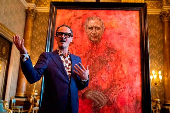 Artist Jonathan Yeo stands in front of his official portrait of Britain’s King Charles III wearing the uniform of the Welsh Guards, of which he was made Regimental Colonel in 1975, in the Blue Drawing Room at Buckingham Palace in London on May 14, 2024. - AFPpix