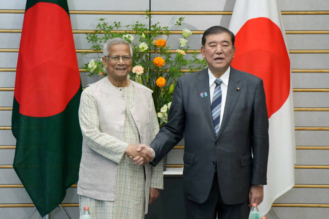 Chief adviser of Bangladesh’s interim government Muhammad Yunus is greeted by Japan’s Prime Minister Shigeru Ishiba prior to their talks at the prime minister’s office in Tokyo, Japan on May 30, 2025. - REUTERSpix