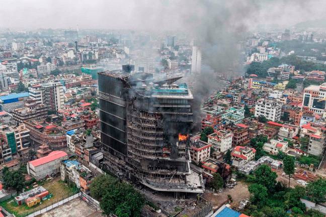 Smoke billows from the burning Hilton Hotels, a day after it was set ablaze by protesters in Kathmandu on September 10, 2025. - AFP pic