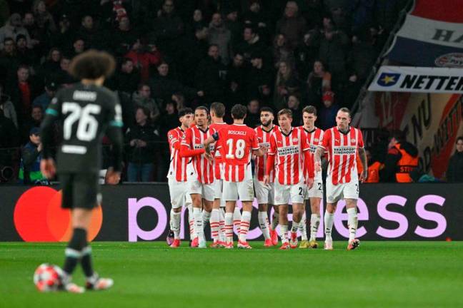 PSV's players celebrates after scoring their first goal during the UEFA Champions League, league phase day 8, football match between PSV Eindhoven (NED) and Liverpool FC (ENG) at the the Philips Stadion, in Eindhoven, on January 29, 2025. - NICOLAS TUCAT / AFP