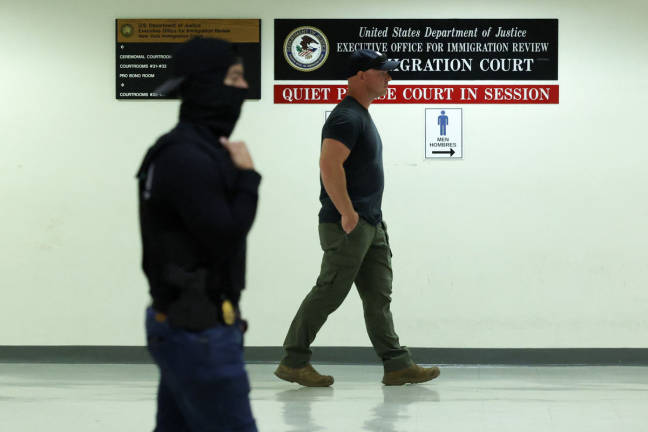 Plainclothes officers with Immigration and Customs Enforcement (ICE) wait in a hallway outside of a courtroom at New York-Federal Plaza Immigration Court inside the Jacob K. Javitz Federal Building in New York City on June 11, 2025. - AFPpix