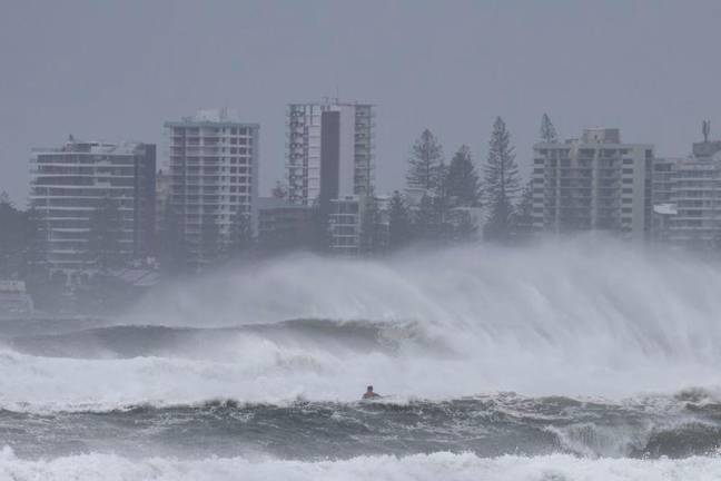 A person riding a jet ski attempts to tow surfboard riders amid record-breaking waves as the outer fringe of Tropical Cyclone Alfred started whipping eastern Australia, in Coolangatta. Tropical Cyclone Alfred was 285 kilometres (180 miles) east of busy Brisbane city. AFPpix