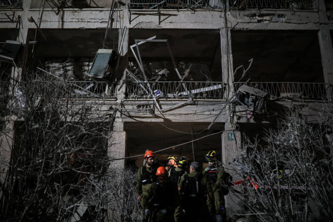 Rescue personnel work at an impact site following missile attack from Iran on Israel, in Ramat Gan June 13, 2025. - REUTERSpix