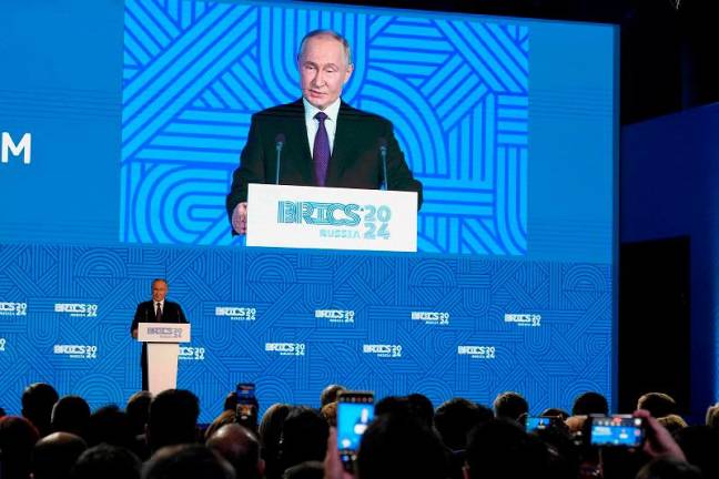 Russian President Vladimir Putin gives a speech during a BRICS business forum in Moscow on October 18, 2024. - Alexander Zemlianichenko / POOL / AFP