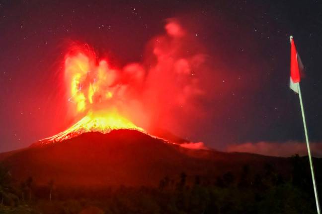 This handout photo taken and released on August 1, 2025 by Indonesia’s Geological Agency shows Mount Lewotobi Laki-Laki spewing lava and volcanic ash up to approximately 10 kilometres high during its eruption as observed from the monitoring post in East Flores, in East Nusa Tenggara province. AFP PHOTO / INDONESIA’S GEOLOGICAL AGENCY