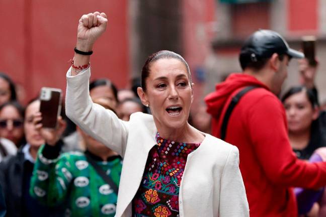 Mexico’s President Claudia Sheinbaum greets supporters on arrival to vote at a polling station during the world-first Mexican elections for all judges and magistrates in Mexico City on June 1, 2025. Mexico began unprecedented elections Sunday allowing voters to choose their judges at all levels, in a country where drug cartels and other vested interests regularly seek to alter the course of justice. - Rodrigo Oropeza / AFP