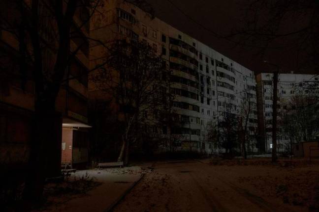 This photograph shows damaged residential buildings and empty street in the Saltivka district that was heavily damaged during Russian attacks in 2022, in Kharkiv, on December 5, 2024, amid the Russian invasion of Ukraine. - Roman PILIPEY / AFP