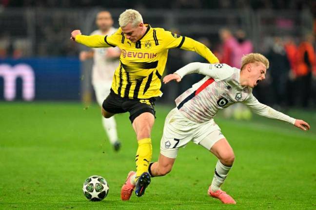 Dortmund’s Norwegian defender #26 Julian Ryerson and Lille’s Icelandic midfielder #07 Hakon Haraldsson vie for the ball during the UEFA Champions League last 16, first leg football match between Borussia Dortmund and OSC Lille in Dortmund, western Germany, on March 4, 2025- AFP pix