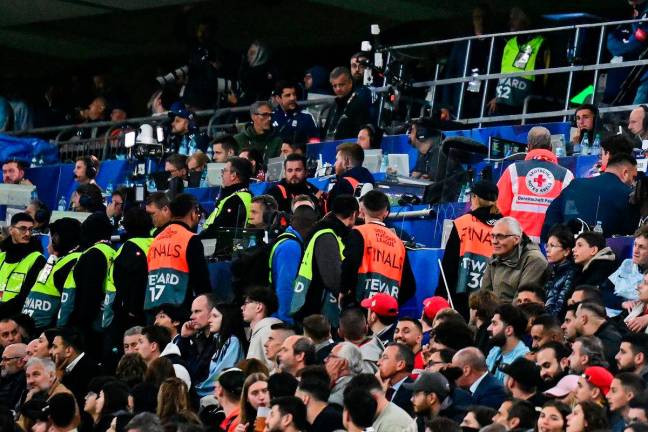 Medics and stewards are seen in the stands after a medical incident occurred during the UEFA Nations League final football match between Portugal and Spain in Munich, southern Germany on June 8, 2025. - Tobias SCHWARZ / AFP