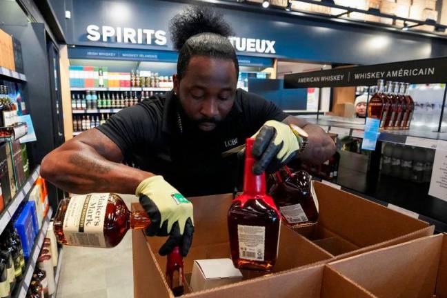 A staff member removes bottles of U.S. alcohol from the shelves of a Liquor Control Board of Ontario (LCBO) store, as part of retaliatory moves against tariffs announced by U.S. President Donald Trump, in Toronto, Ontario, Canada. REUTERS Pix