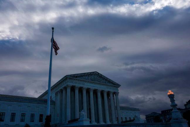 A U.S. Flag flutters outside of the United States Supreme Court Building, in Washington, U.S., December 5, 2024. - REUTERS/Evelyn Hockstein/File Photo