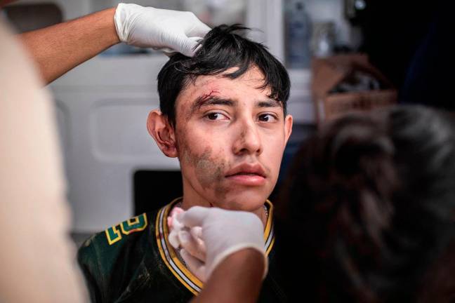 - A young man receives medical attention in the municipality of Alamo, Veracruz state, Mexico on October 12, 2025. The death toll from heavy rains in Mexico rose to 44 after the Mexican government confirmed three more fatalities on Sunday, as civilian and military rescuers struggle to clear roads and reach cut-off communities. - AFP