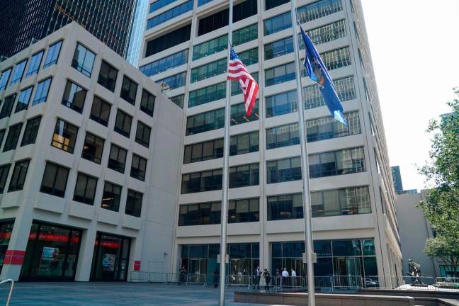 Flags fly at half-staff outside the 345 Park Avenue building, the scene of last night’s deadly shootings in Midtown Manhattan in New York on July 29, 2025 - AFPPix
