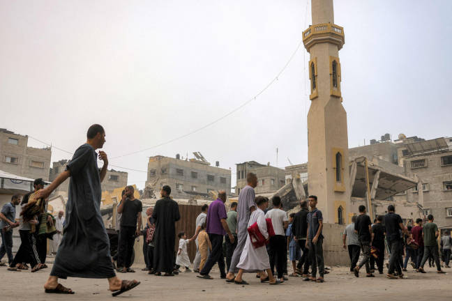 Muslim worshippers walk away after attending the early morning prayers for Eid al-Adha, the feast of sacrifice, at the Nour mosque in the Abu Amin neighbourhood in northeastern Gaza City on June 6, 2025. - AFPpix