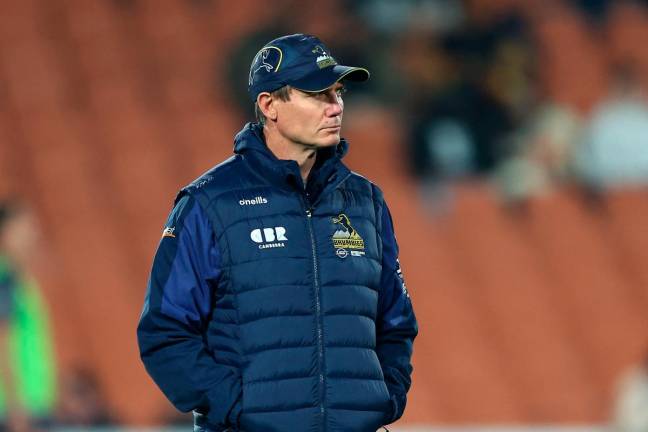 Brumbies' Coach Stephen Larkham looks on ahead of the Super Rugby Pacific semi final match between the Chiefs and Brumbies at FMG Stadium in Hamilton on June 14, 2025. - DJ Mills / AFP