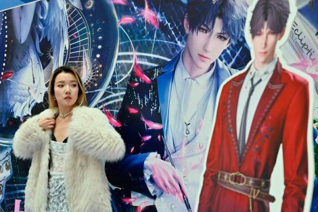 A woman poses during a birthday celebration event for Rafayel, a virtual character in the romantic mobile game “Love and Deepspace”, at a shopping mall in Beijing. AFPpix