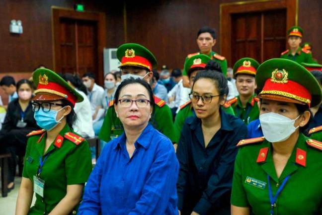 Vietnamese property tycoon Truong My Lan (C-L) looks on at a court in Ho Chi Minh city on March 25, 2025. The appeal of a Vietnamese property tycoon convicted of money laundering began.AFPpix