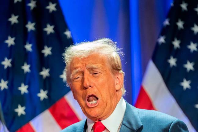 US President-elect Donald Trump gestures as he attends a meeting with House Republicans at the Hyatt Regency hotel in Washington, DC on November 13, 2024. - Allison ROBBERT / AFP