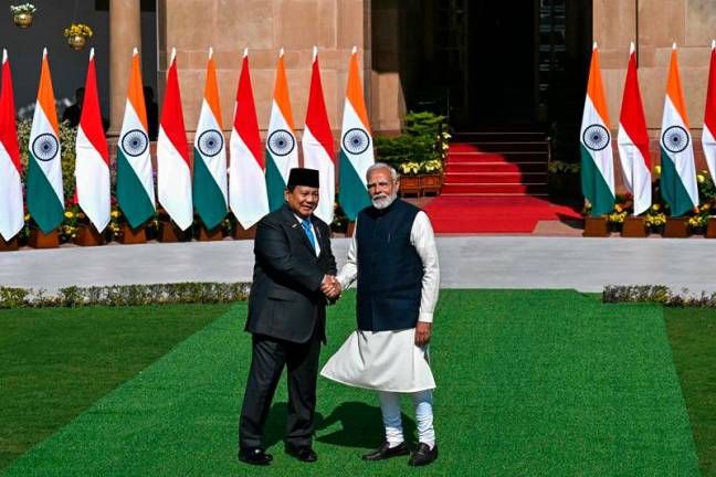 Indonesian President Prabowo Subianto (L) shakes hand with India's Prime Minister Narendra Modi at Hyderabad House in New Delhi on January 25, 2025. - Money SHARMA / AFP