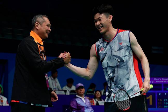 Wong Tat Meng (left) with Lee Zii Jia during the 2022 Asian Games. - Bernama file pic
