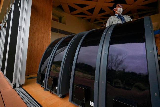 This photo taken on April 24, 2025 shows perovskite solar panels on display at the Okuma Town Hall in Okuma, Fukushima prefecture, an area of the town recently rebuilt just a few kilometres (miles) west of the stricken Fukushima Daiichi nuclear power plant. - AFP