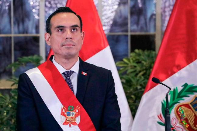 Peru’s interim President Jose Jeri looks on during the inauguration ceremony of his cabinet at the Presidential Palace in Lima on October 13, 2025. Peru’s interim government declared a state of emergency on October 21, 2025, in Lima and the neighboring port of Callao in an effort to curb a wave of violence and extortion blamed on organized crime. - AFP