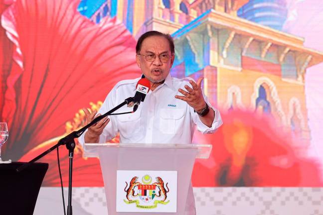 Prime Minister Datuk Seri Anwar Ibrahim speaking at the National Month Launch and Jalur Gemilang Flying Ceremony 2025 at Dataran Tanjung Emas today. - Bernama